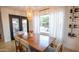 Bright dining room with view of pool and backyard, complete with a wine rack and modern lighting at 13451 S 47Th Way, Phoenix, AZ 85044