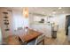 Dining area with wooden table, modern chairs, a wine rack, and seamless transition into the kitchen at 13451 S 47Th Way, Phoenix, AZ 85044