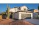 Well maintained two-story home with desert landscaping and a dark colored two-car garage door at 13451 S 47Th Way, Phoenix, AZ 85044