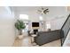 Bright living room featuring high ceilings, large windows, a fireplace and modern staircase at 13451 S 47Th Way, Phoenix, AZ 85044