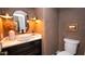 Stylish powder room with designer fixtures, vessel sink, decorative mirror and elegant wall accents at 13451 S 47Th Way, Phoenix, AZ 85044