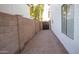 Narrow side yard features neutral-toned gravel ground cover between the fence and the home's white exterior at 13451 S 47Th Way, Phoenix, AZ 85044