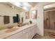 Bright bathroom featuring double sinks with tile countertops and a glass-enclosed shower at 14493 S Country Club Dr, Arizona City, AZ 85123