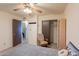 Bright bedroom with a ceiling fan, chair and closet offers a relaxing space at 14493 S Country Club Dr, Arizona City, AZ 85123