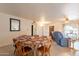 Spacious dining area with a table and seating for six, adjacent to a comfortable living space at 14493 S Country Club Dr, Arizona City, AZ 85123