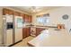 Functional kitchen with ample counter space, classic cabinetry, and natural light from the window at 14493 S Country Club Dr, Arizona City, AZ 85123