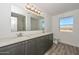 Bathroom featuring double vanity, modern fixtures, and wood-style flooring at 1510 E Red Range Way, Phoenix, AZ 85085