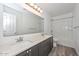 Modern bathroom featuring double sinks, a large mirror, and a shower with a tub at 1510 E Red Range Way, Phoenix, AZ 85085