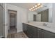 Bathroom with double sinks, modern vanity, and walk-in closet at 1510 E Red Range Way, Phoenix, AZ 85085