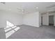 Spacious bedroom with plush gray carpeting, a ceiling fan, and an abundance of light at 1510 E Red Range Way, Phoenix, AZ 85085