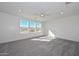 Spacious bedroom with plush gray carpeting, a ceiling fan, and plenty of natural light from the windows at 1510 E Red Range Way, Phoenix, AZ 85085