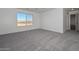 Spacious bedroom with plush carpeting, large window letting in natural light at 1510 E Red Range Way, Phoenix, AZ 85085