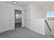 Bright hallway featuring gray carpet, white doors, and a view of the mountains at 1510 E Red Range Way, Phoenix, AZ 85085