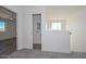 Bright hallway with laundry and bedroom views, complemented by neutral carpet and ample natural light at 1510 E Red Range Way, Phoenix, AZ 85085