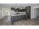 Modern kitchen featuring gray cabinets, white countertops, stainless steel appliances, and hardwood floors at 1510 E Red Range Way, Phoenix, AZ 85085