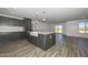 Spacious kitchen with an island featuring a farm sink, gray cabinets, and an open-concept layout at 1510 E Red Range Way, Phoenix, AZ 85085