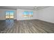 Bright living room with sliding glass doors, mountain views, and grey wood-look flooring at 1510 E Red Range Way, Phoenix, AZ 85085