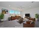 Comfortable living room with a ceiling fan, modern furnishings and plenty of light from the windows at 1510 E Red Range Way, Phoenix, AZ 85085