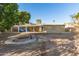 Large backyard with a central firepit and covered patio space at 1549 W Peralta Ave, Mesa, AZ 85202