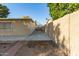 Large backyard with tall walls bordering the property line and side building at 1549 W Peralta Ave, Mesa, AZ 85202