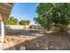 Expansive backyard area with a circular brick fire pit and sparse ground cover at 1549 W Peralta Ave, Mesa, AZ 85202