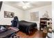 Bedroom featuring hardwood floors, white walls and ceiling, and a gaming chair at 1549 W Peralta Ave, Mesa, AZ 85202