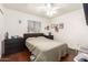 Neutral bedroom featuring a queen bed, hardwood floors, and natural light from the window at 1549 W Peralta Ave, Mesa, AZ 85202