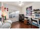 Bright bedroom featuring a desk, hardwood floors, white walls and ceiling, and a large window at 1549 W Peralta Ave, Mesa, AZ 85202