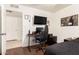 Bedroom featuring hardwood floors, white walls and ceiling, and a gaming chair at 1549 W Peralta Ave, Mesa, AZ 85202