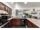 Cozy kitchen features granite countertops, stainless steel appliances, and wood cabinets at 1549 W Peralta Ave, Mesa, AZ 85202