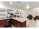 Open kitchen featuring a large granite countertop island and view of the living room at 1549 W Peralta Ave, Mesa, AZ 85202