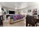 A modern living room featuring sleek tile floors, contemporary decor, and a large TV at 1549 W Peralta Ave, Mesa, AZ 85202