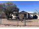 Charming single-story home with a chain-link fenced yard and mature tree at 1634 S 5Th St, Phoenix, AZ 85004