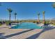 Resort style pool with views of mountains, palm trees and comfortable patio furniture at 17192 W Rocklin St, Surprise, AZ 85388