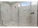 Walk-in shower with marble tile surround and a bench at 17192 W Rocklin St, Surprise, AZ 85388