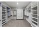 Spacious walk-in closet with built in shelves and carpeted floors at 17192 W Rocklin St, Surprise, AZ 85388