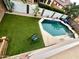 Aerial view of the backyard featuring a pool, patio area, and artificial grass for low maintenance at 17420 W Mohave St, Goodyear, AZ 85338