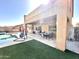 Exterior view of the covered patio and backyard artificial turf area with views of the adjacent pool at 17420 W Mohave St, Goodyear, AZ 85338