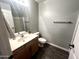 Neutral toned bathroom with a modern vanity, tile floors, and framed mirror over the sink at 17420 W Mohave St, Goodyear, AZ 85338