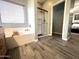 Well-lit bathroom with a soaking tub, shower, and wood-look flooring at 17420 W Mohave St, Goodyear, AZ 85338