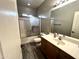 Bathroom featuring a glass shower door, neutral color walls, and wood look tile flooring at 17420 W Mohave St, Goodyear, AZ 85338