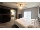 Well-lit primary bedroom with ensuite bathroom access, a ceiling fan, and neutral tones at 17420 W Mohave St, Goodyear, AZ 85338