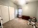 Bedroom with carpet, a ceiling fan, and white sliding closet doors at 17420 W Mohave St, Goodyear, AZ 85338