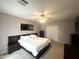 Bright bedroom with a large bed, ceiling fan, and a wall mounted television at 17420 W Mohave St, Goodyear, AZ 85338