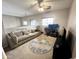 Bonus room with carpet and a large, comfortable couch at 17420 W Mohave St, Goodyear, AZ 85338