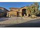 Inviting two-story home showcasing neutral stucco, a tile roof, and a spacious three-car garage at 17420 W Mohave St, Goodyear, AZ 85338