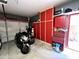 Garage featuring motorcycles, cabinets, tool chest, and storage at 17420 W Mohave St, Goodyear, AZ 85338