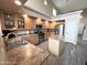 Bright kitchen features wooden cabinetry, stainless appliances, tile floors, and a center island at 17420 W Mohave St, Goodyear, AZ 85338