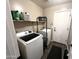 Practical laundry room featuring modern washer and dryer, shelving, and neutral color paint at 17420 W Mohave St, Goodyear, AZ 85338