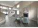 Spacious living room with high ceilings, gray plank flooring, and a stone fireplace at 17420 W Mohave St, Goodyear, AZ 85338